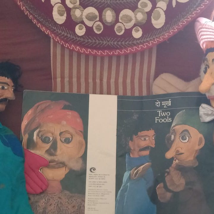 Two glove puppets beside the CCRT Two Fools booklet