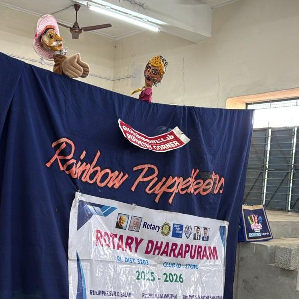 Two puppet characters above the curtain, mid-performance
